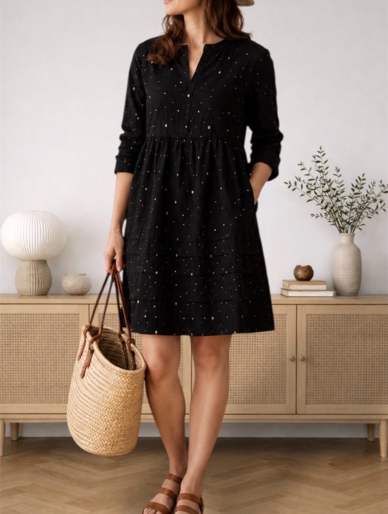 petite woman in a short, loose black dress with no defined waistline