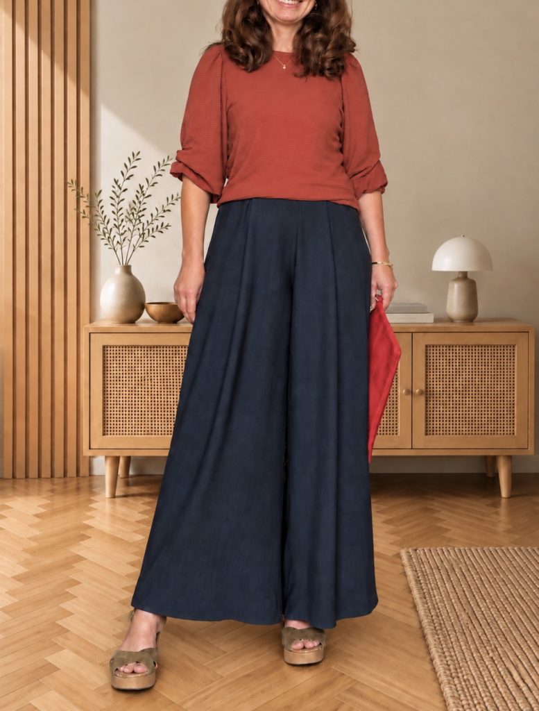 coral red outfit: handmade coral red jo pullover with wide dusky green trousers, a scarlet clutch and olive sandals