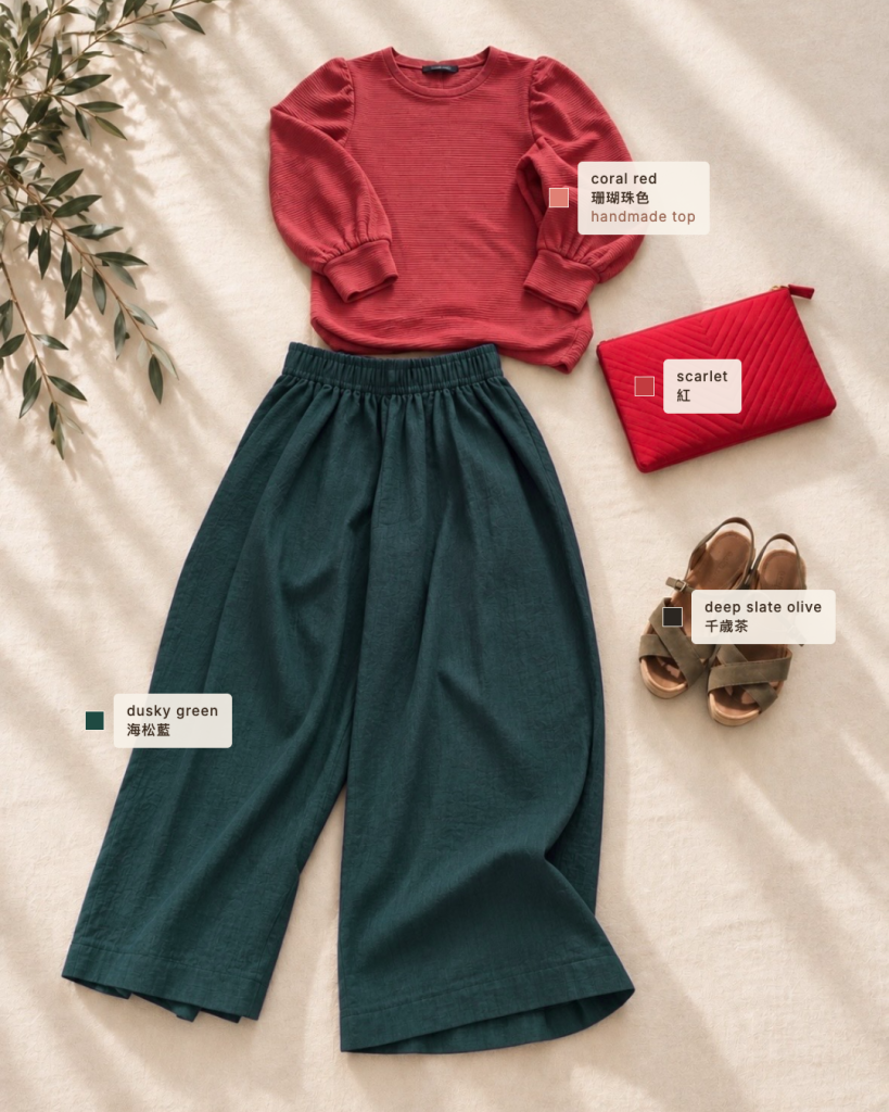 flatlay of the coral red outfit with colour labels: coral red top, dusky green trousers, scarlet clutch and deep slate olive sandals